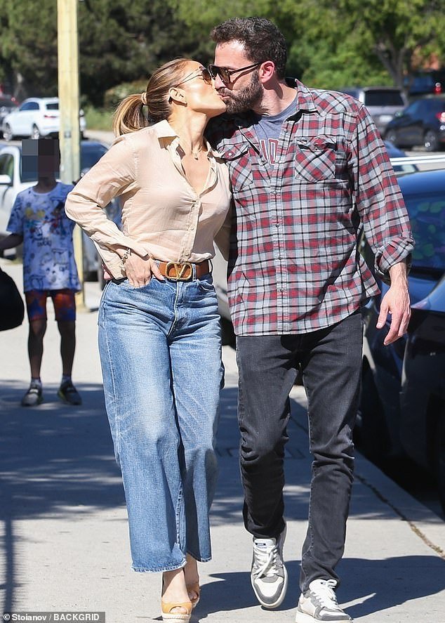 Jennifer Lopez and Ben Affleck share a sweet kiss while strolling in Los Angeles with son Samuel